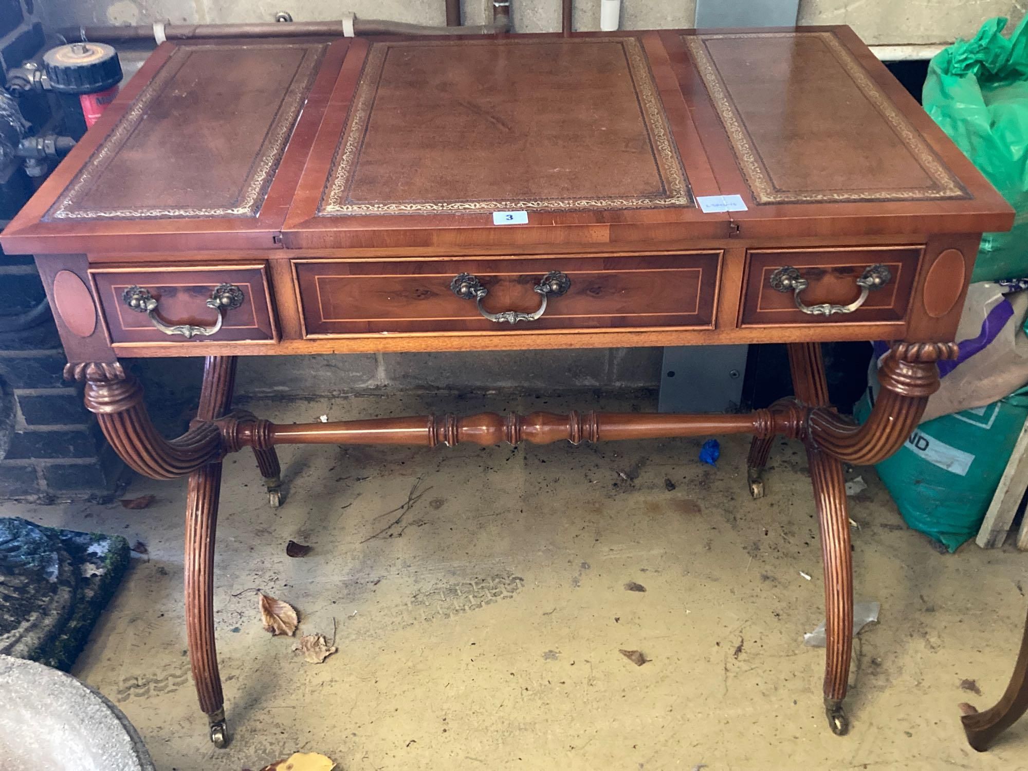 A modern yew wood and mahogany writing table, with sliding backgammon and chessboard top, width 92cm